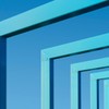 Abstract view of blue metal frames aligned against a vibrant blue sky, creating a geometric pattern.